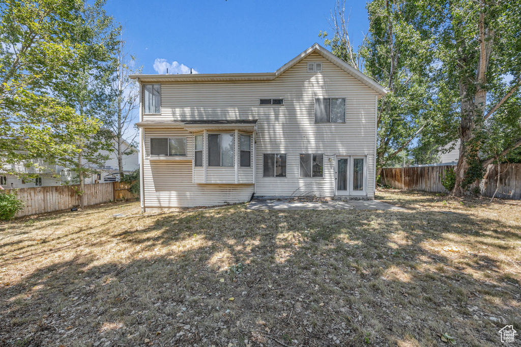 Back of property with a fenced backyard and a patio area