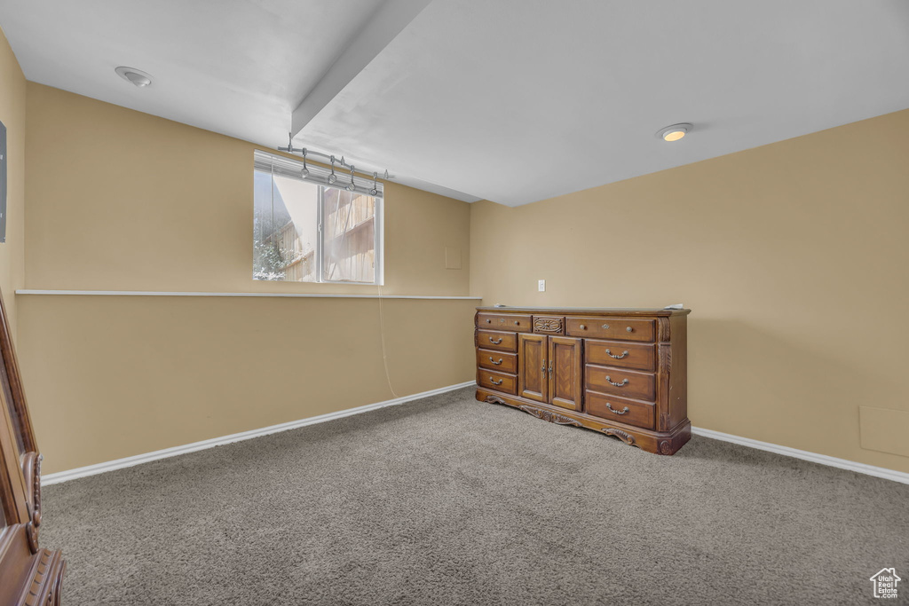 Unfurnished bedroom featuring carpet flooring and baseboards