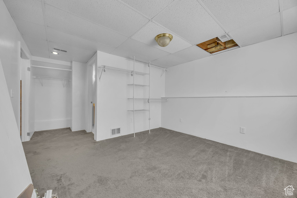 Unfurnished bedroom with carpet floors and a paneled ceiling