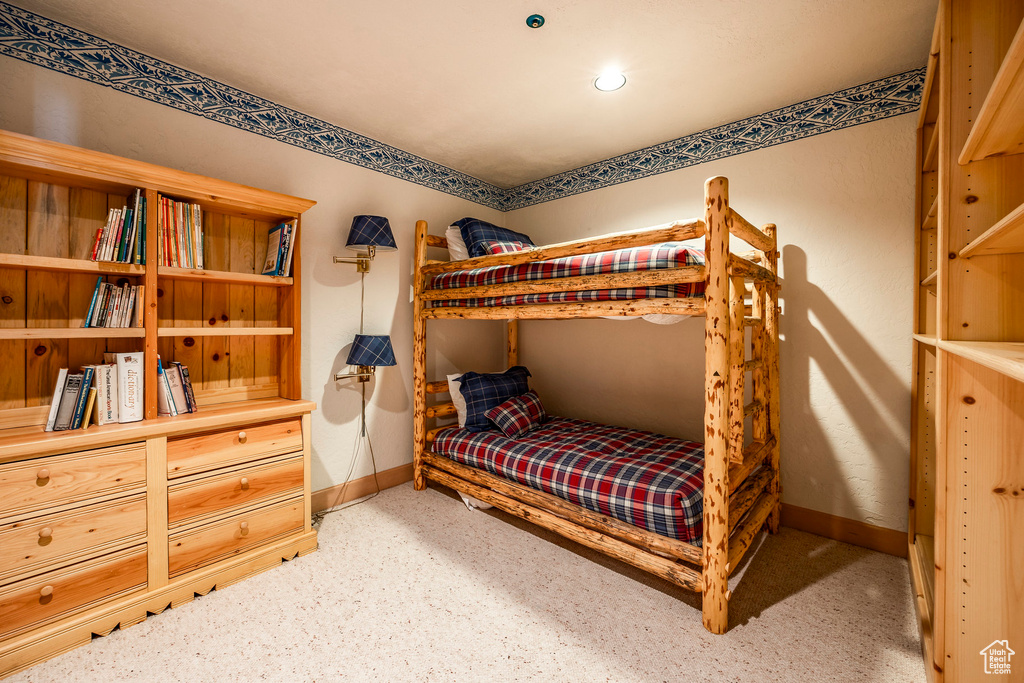 Bedroom featuring light carpet