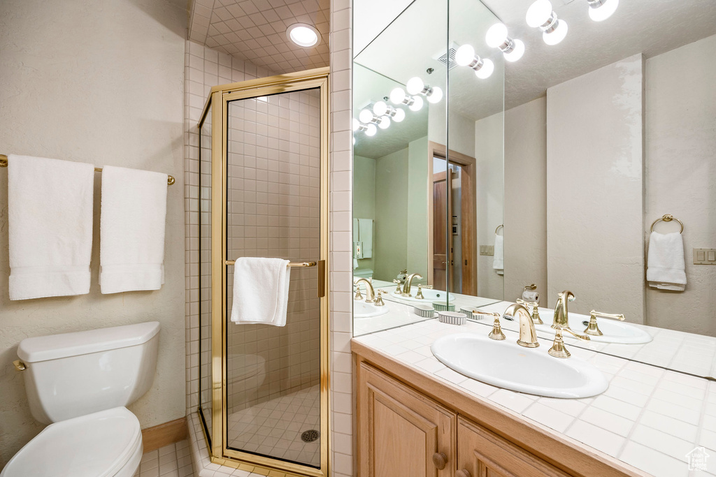 Full bathroom featuring vanity and a stall shower