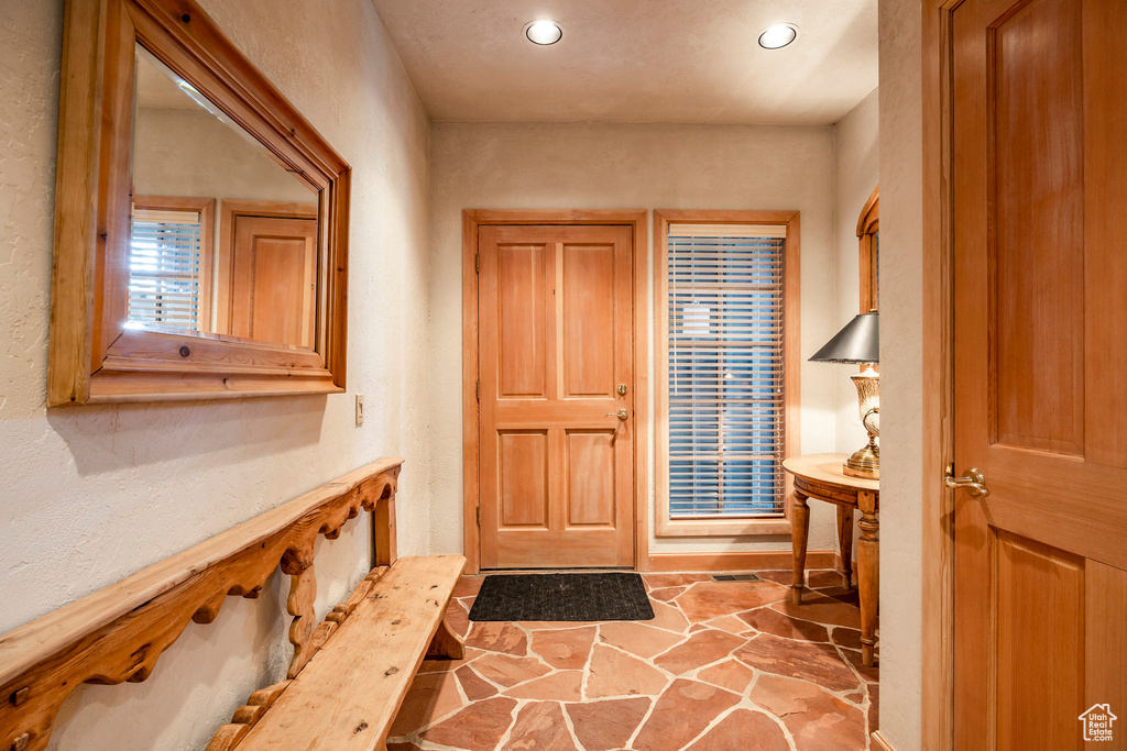 Foyer featuring recessed lighting and stone flooring