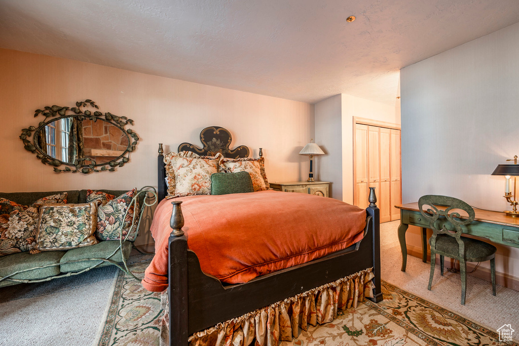 Carpeted bedroom featuring a closet