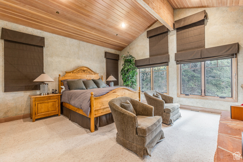 Bedroom with a wooden ceiling with exposed beams and high vaulted ceiling