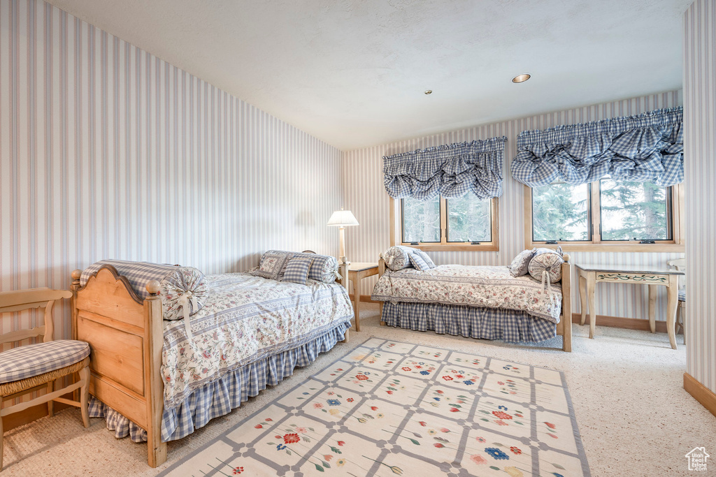 Bedroom featuring wallpapered walls