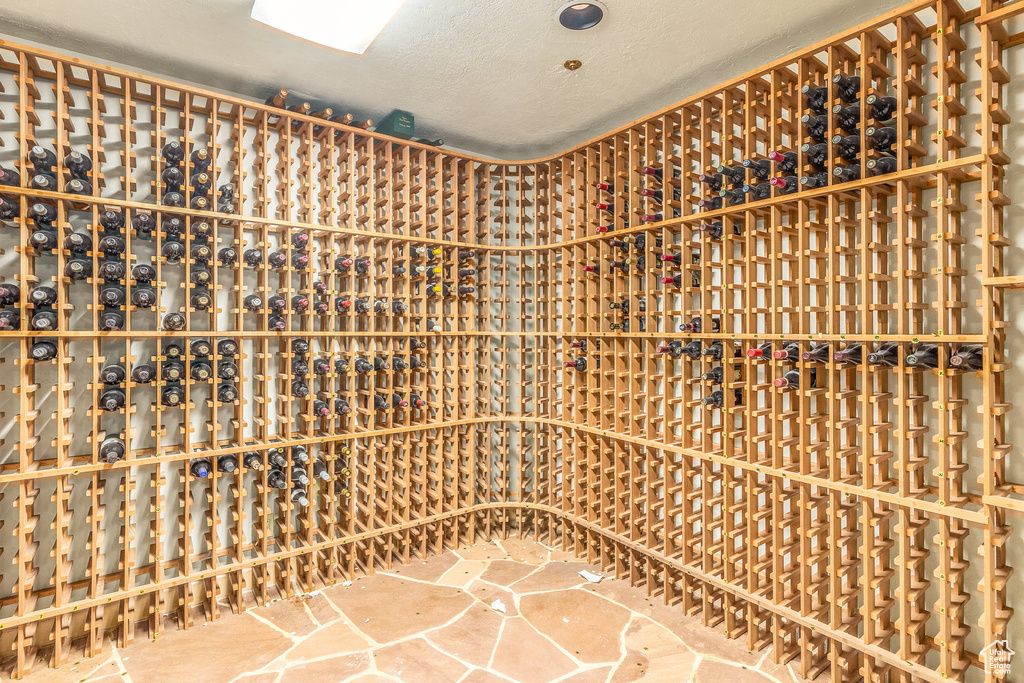 Wine area featuring a textured ceiling and stone finish floors