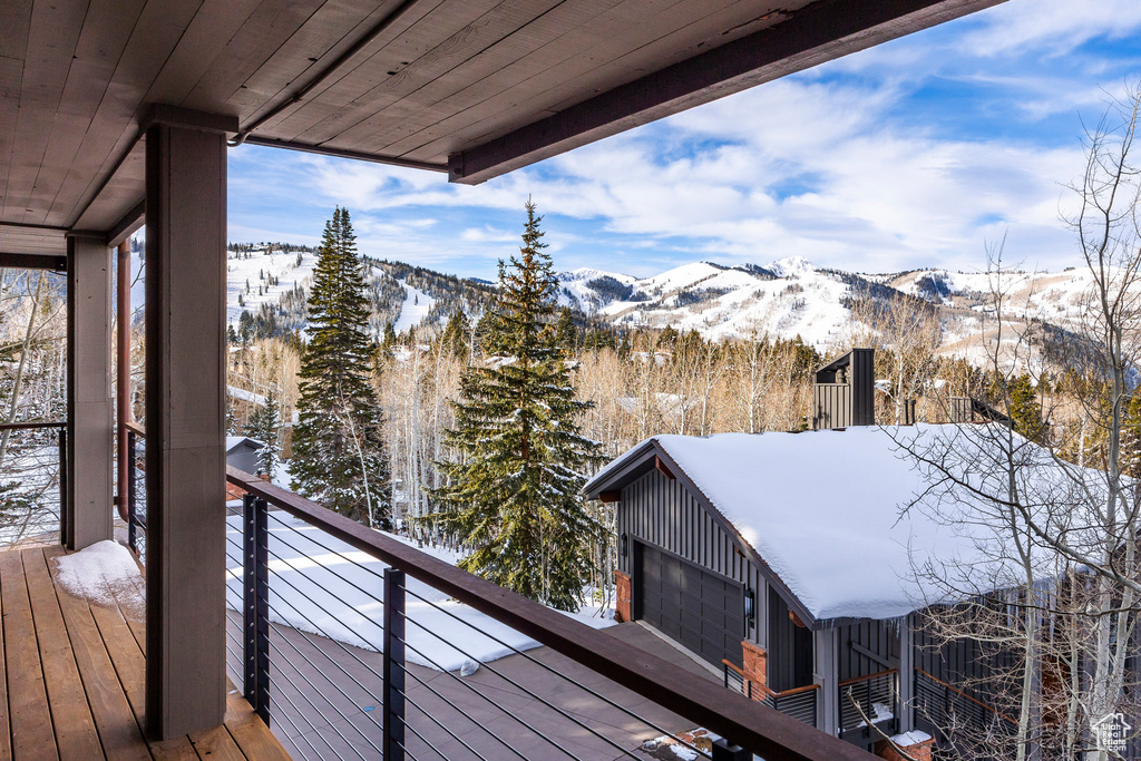Snow covered deck with a mountain view