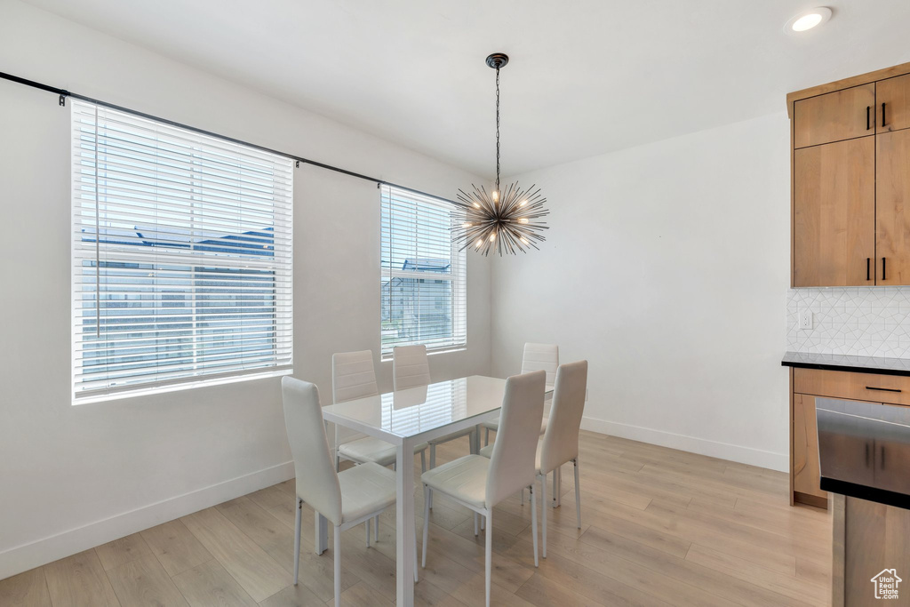 Dining room featuring a chandelier, light wood-style flooring, and recessed lighting