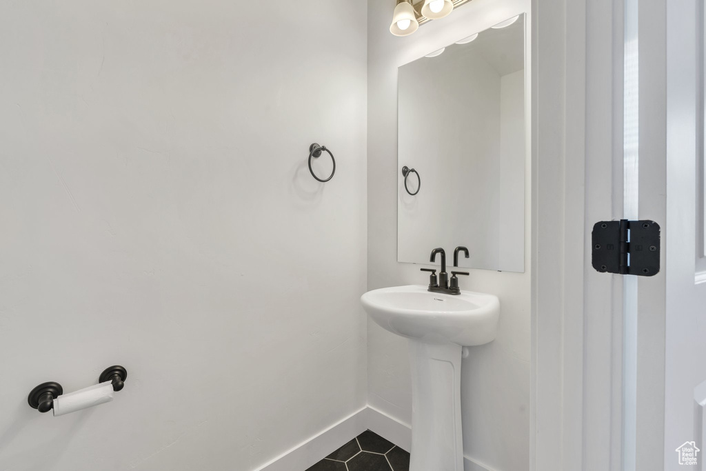 Bathroom featuring tile patterned floors and baseboards