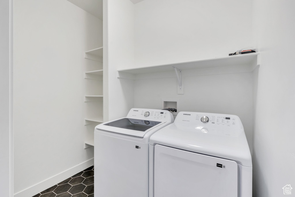 Laundry room featuring washing machine and clothes dryer and baseboards