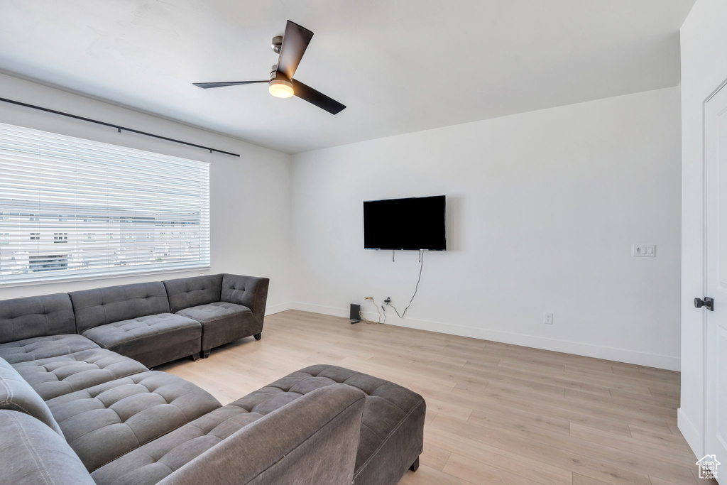Living area featuring ceiling fan and light wood-style floors