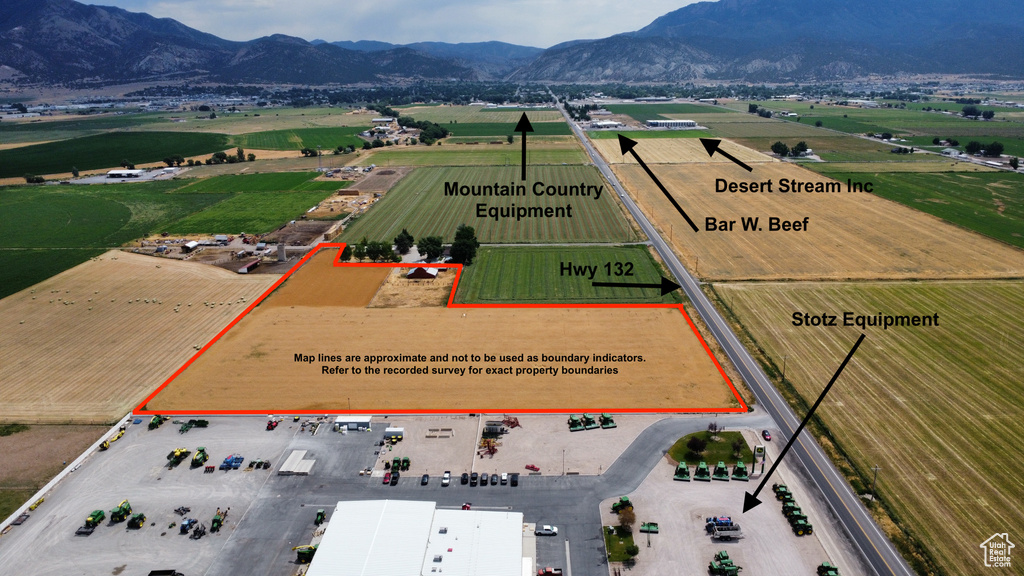 Aerial view of property's location featuring a mountain backdrop and property parcel outlined