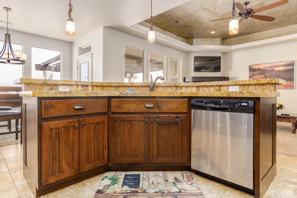 Kitchen featuring dishwasher, a tray ceiling, hanging light fixtures, and ceiling fan