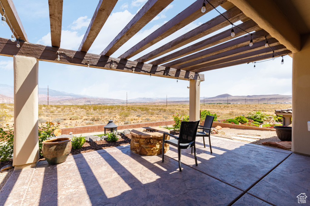 View of patio / terrace with a mountain view, a pergola, and a rural view