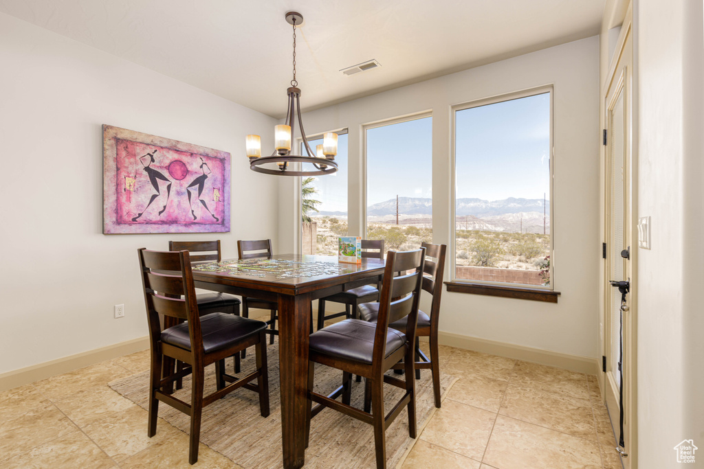 Dining room with a chandelier, a mountain view, and light tile patterned floors