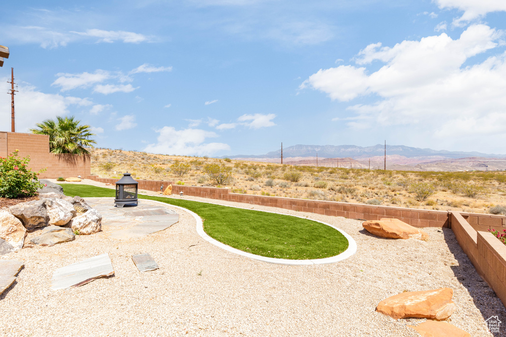 Fenced backyard with a mountain view