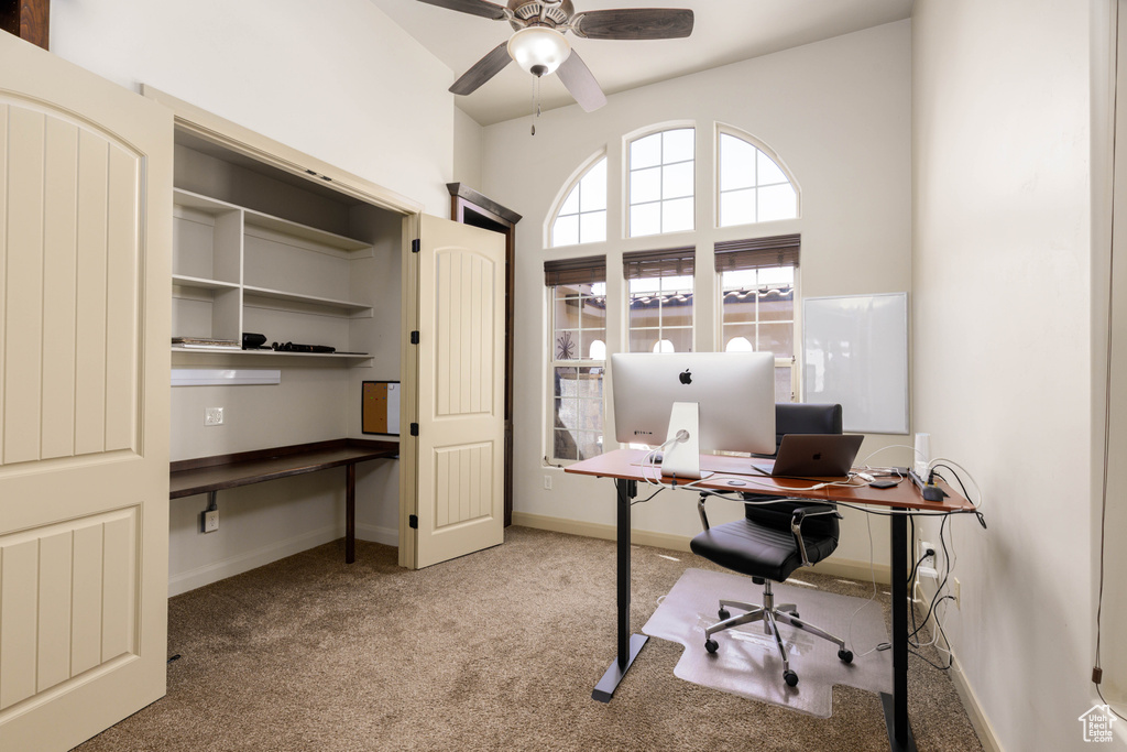 Office space with carpet and a ceiling fan