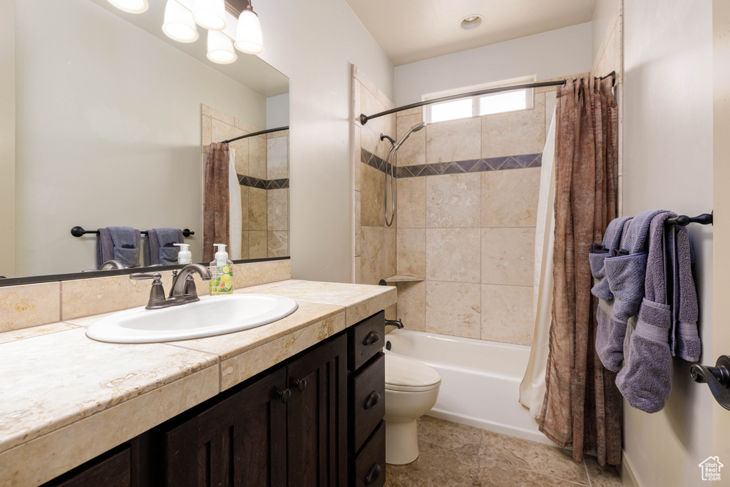 Bathroom with vanity and shower / tub combo with curtain