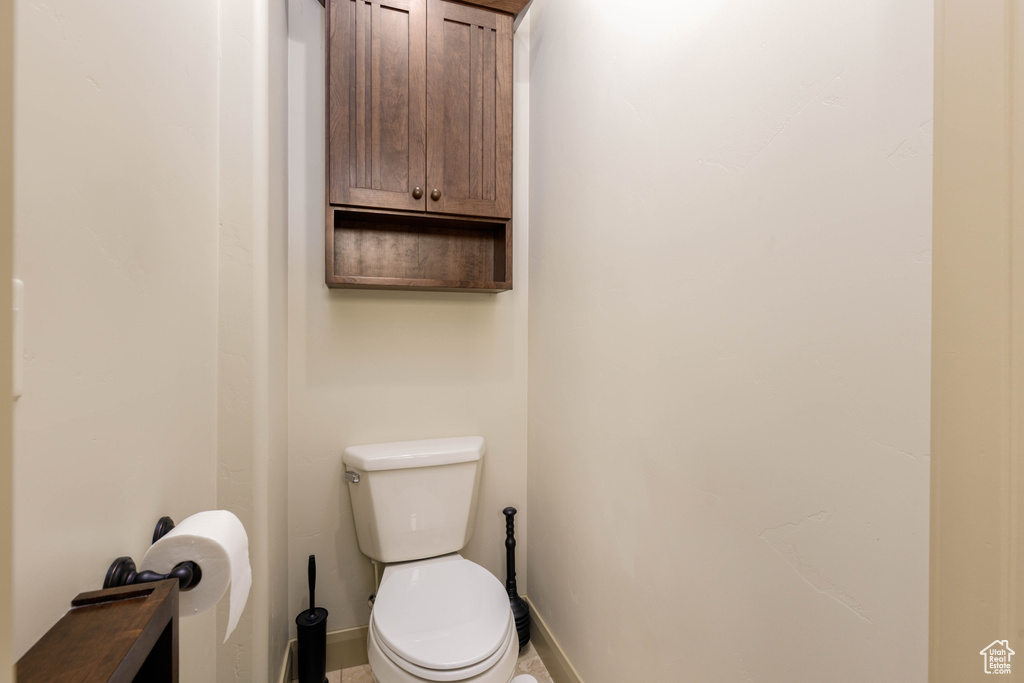 Bathroom featuring baseboards and toilet