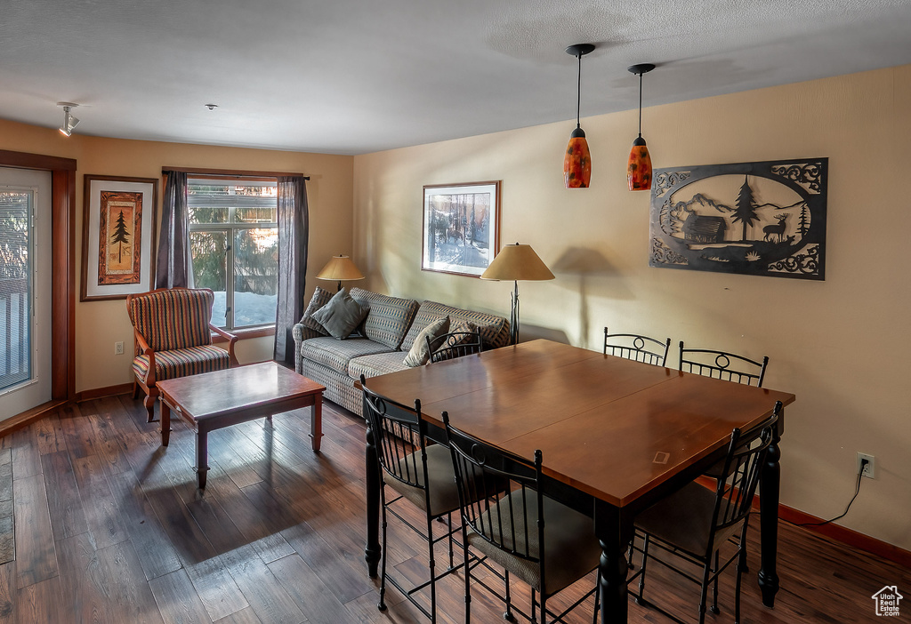 Dining area with baseboards and wood finished floors