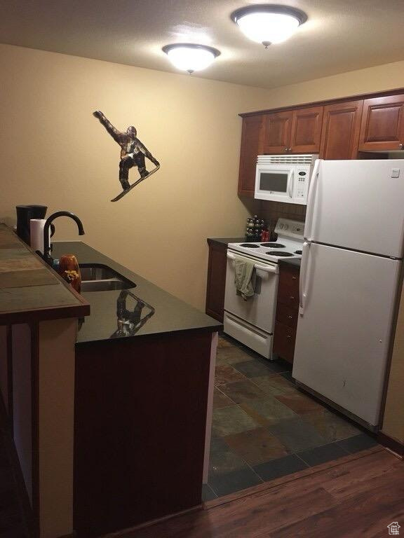 Kitchen with white appliances and brown cabinets