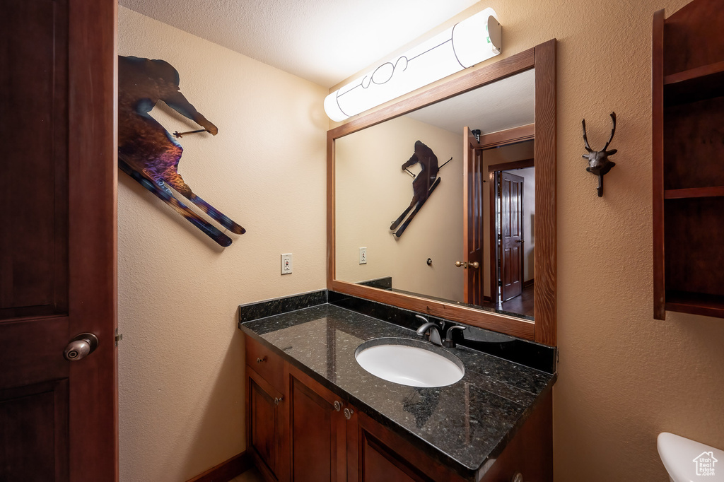 Bathroom featuring vanity and toilet