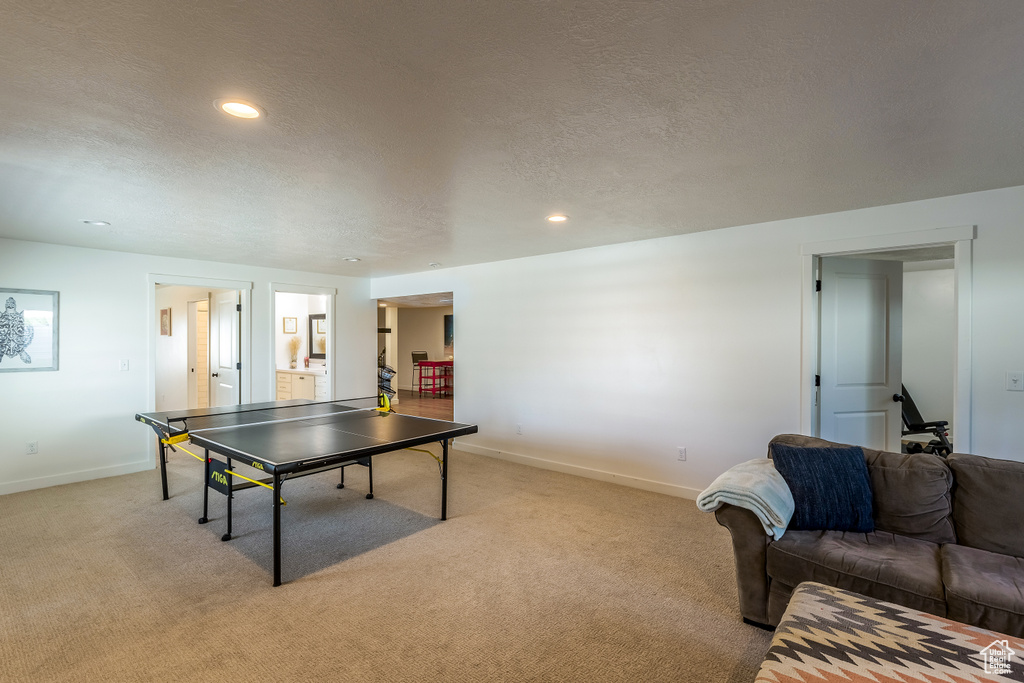 Game room with light carpet, a textured ceiling, and recessed lighting
