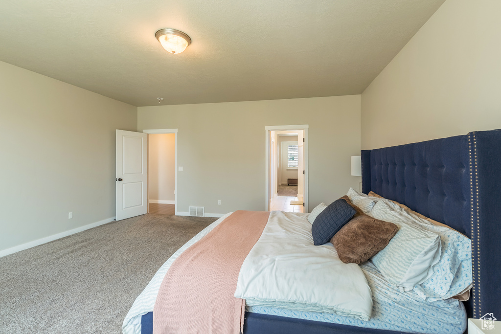 Carpeted bedroom with baseboards