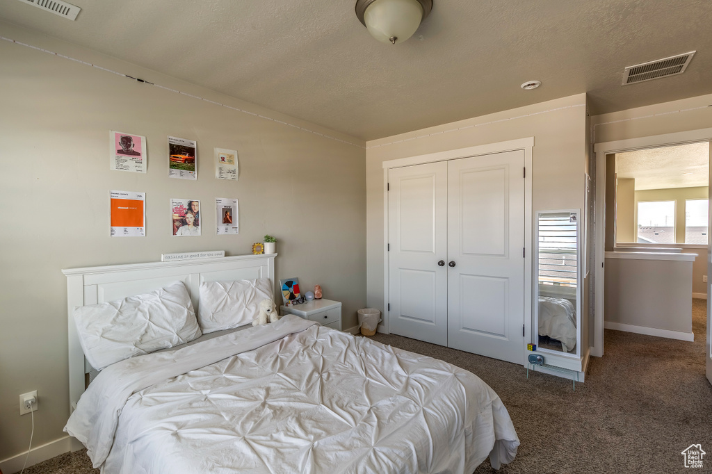 Bedroom with carpet and a closet