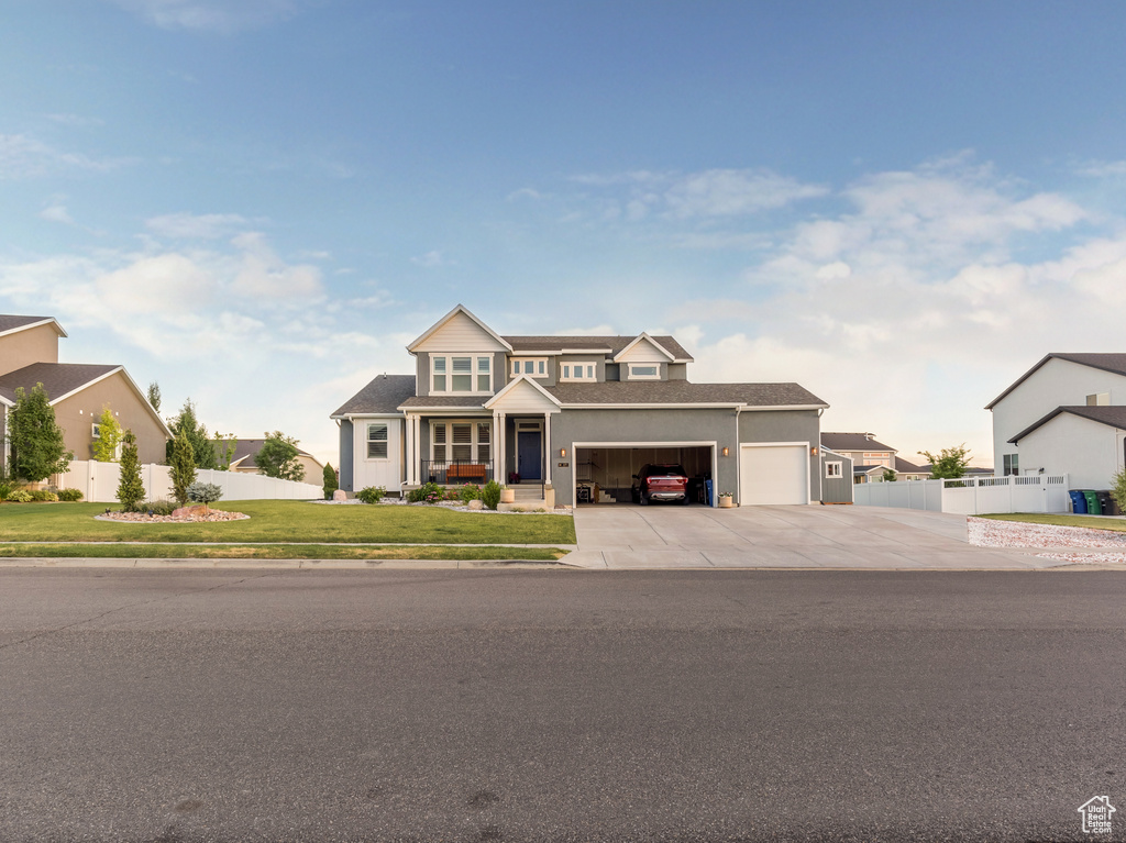 View of front of home with a garage, driveway, and a residential view
