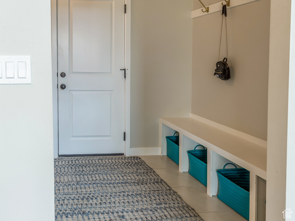 Mudroom with tile patterned floors