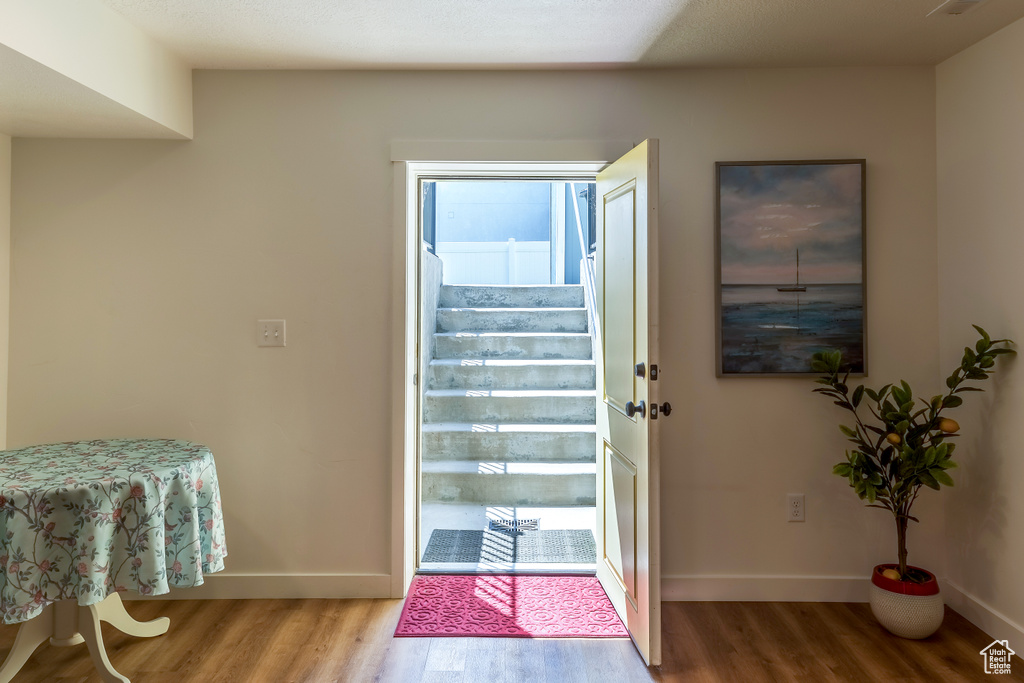 Foyer entrance with wood finished floors