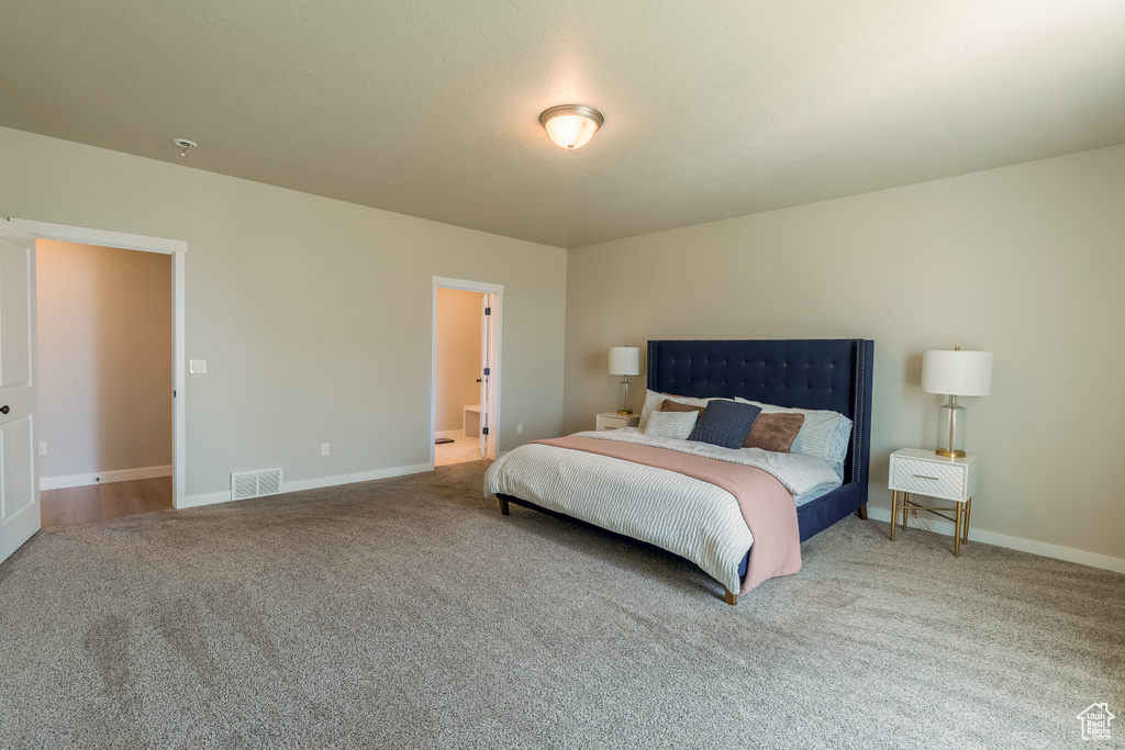 Carpeted bedroom featuring baseboards