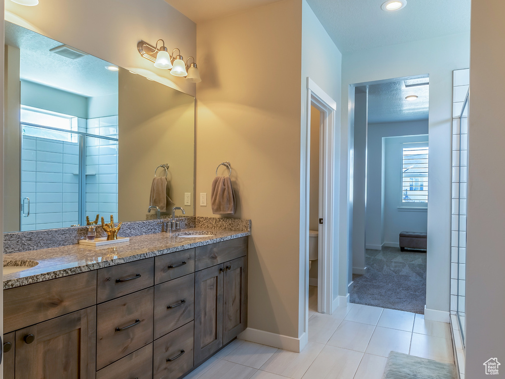 Bathroom with double vanity and tile patterned floors