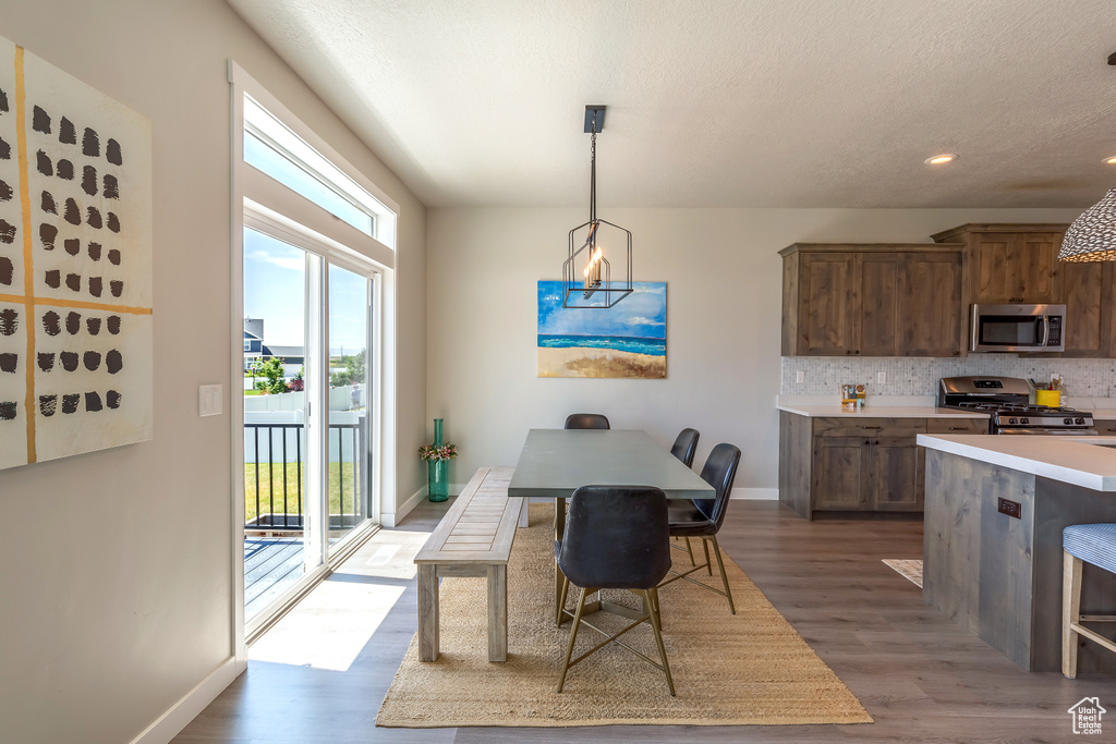 Dining space featuring wood finished floors and recessed lighting
