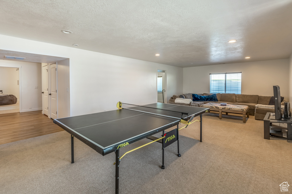 Playroom featuring carpet flooring, recessed lighting, and a textured ceiling