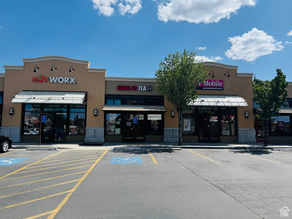 View of commercial property with uncovered parking