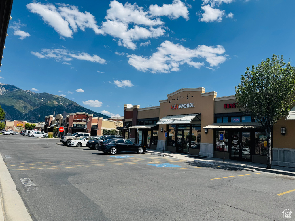 View of commercial location with uncovered parking and a mountain view
