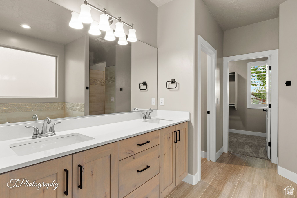 Bathroom with double vanity and a tile shower