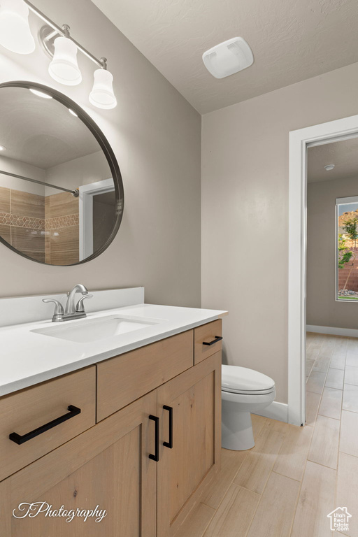 Full bath featuring vanity, wood finished floors, and a shower