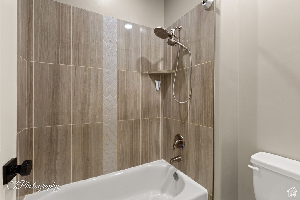 Bathroom featuring toilet and shower / tub combination