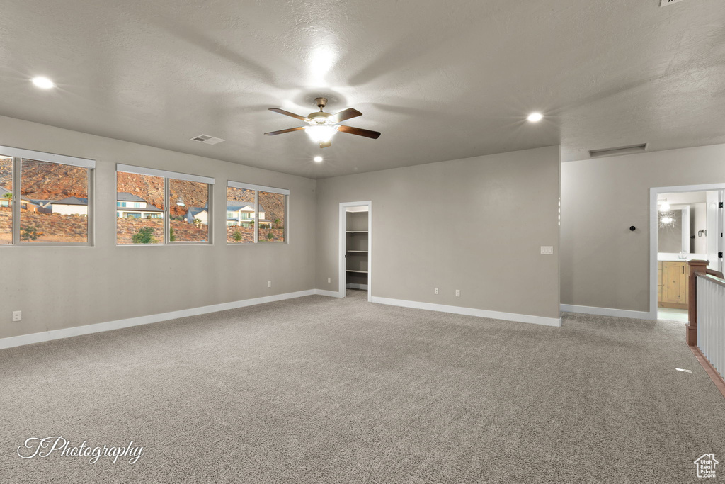 Unfurnished room featuring ceiling fan, light carpet, and recessed lighting