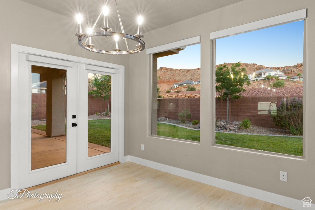 Doorway to outside featuring french doors, a chandelier, a mountain view, and wood finished floors