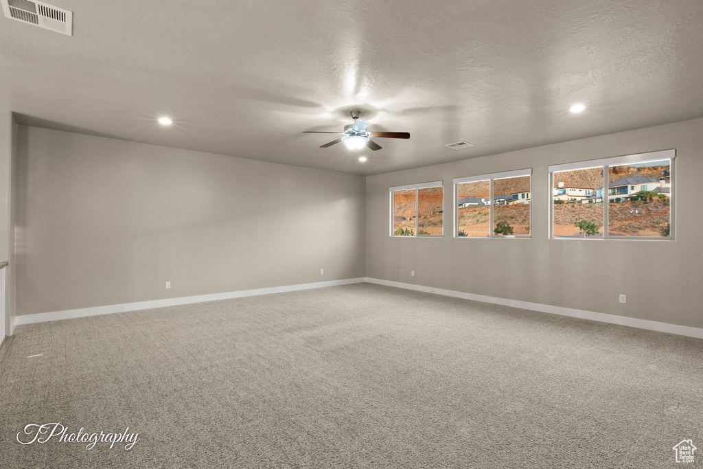 Unfurnished room with ceiling fan, recessed lighting, carpet floors, and a textured ceiling
