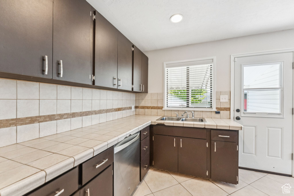 Kitchen featuring dishwasher, backsplash, light tile patterned flooring, tile counters, and recessed lighting