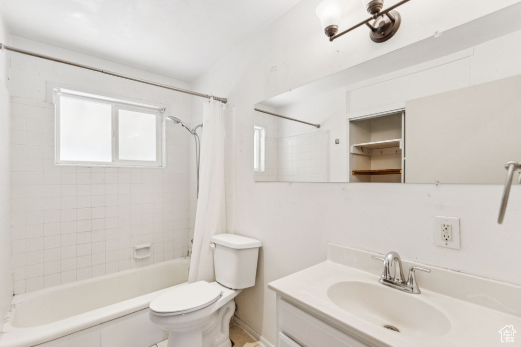 Bathroom featuring shower / bath combo and vanity