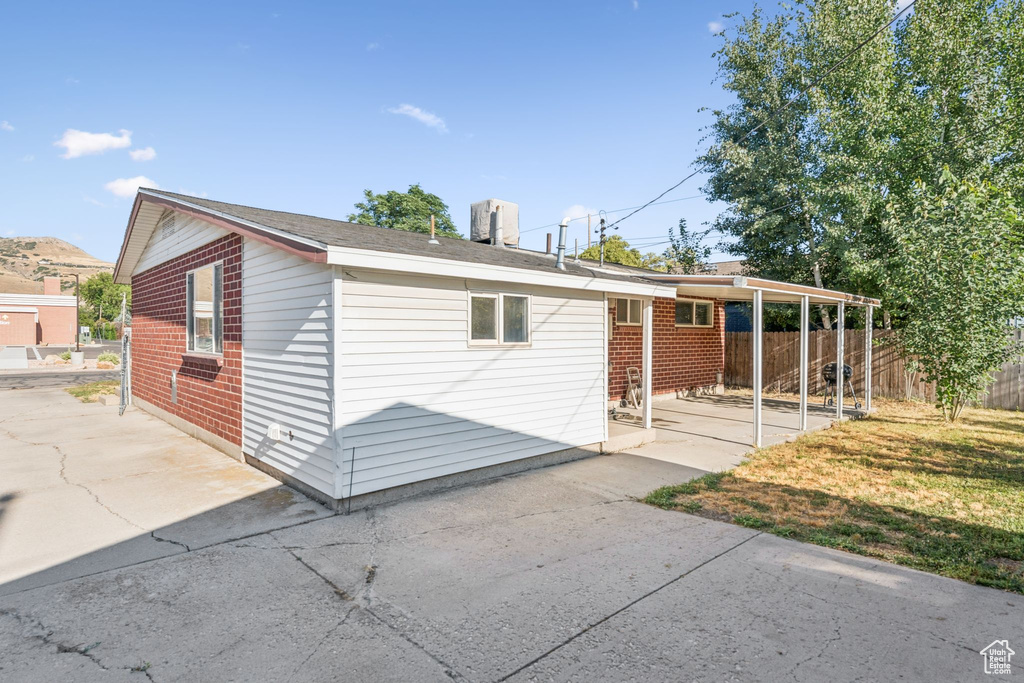 Back of house with a patio area and brick siding