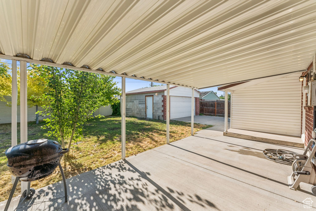 Fenced backyard with area for grilling, a patio area, and an outdoor structure