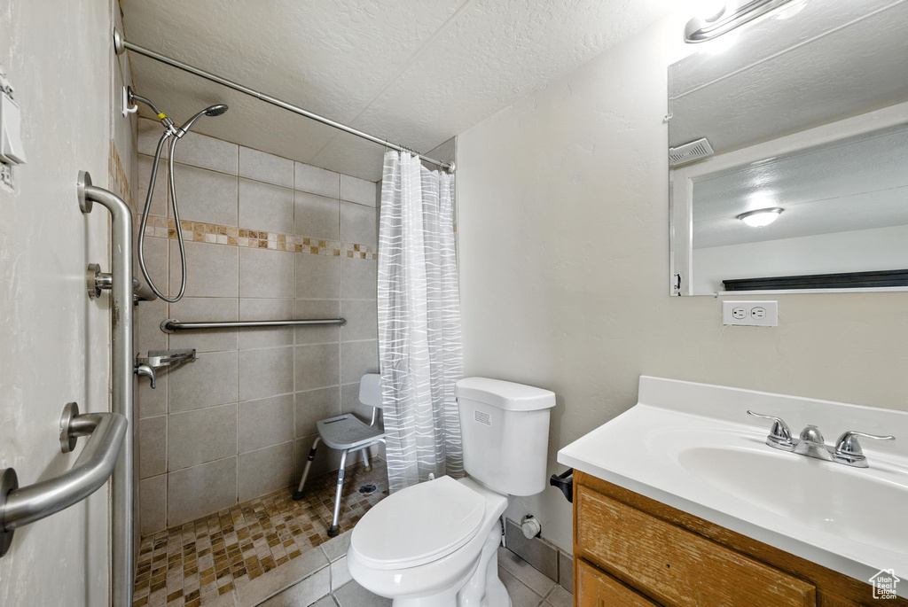 Bathroom with vanity and a tile shower