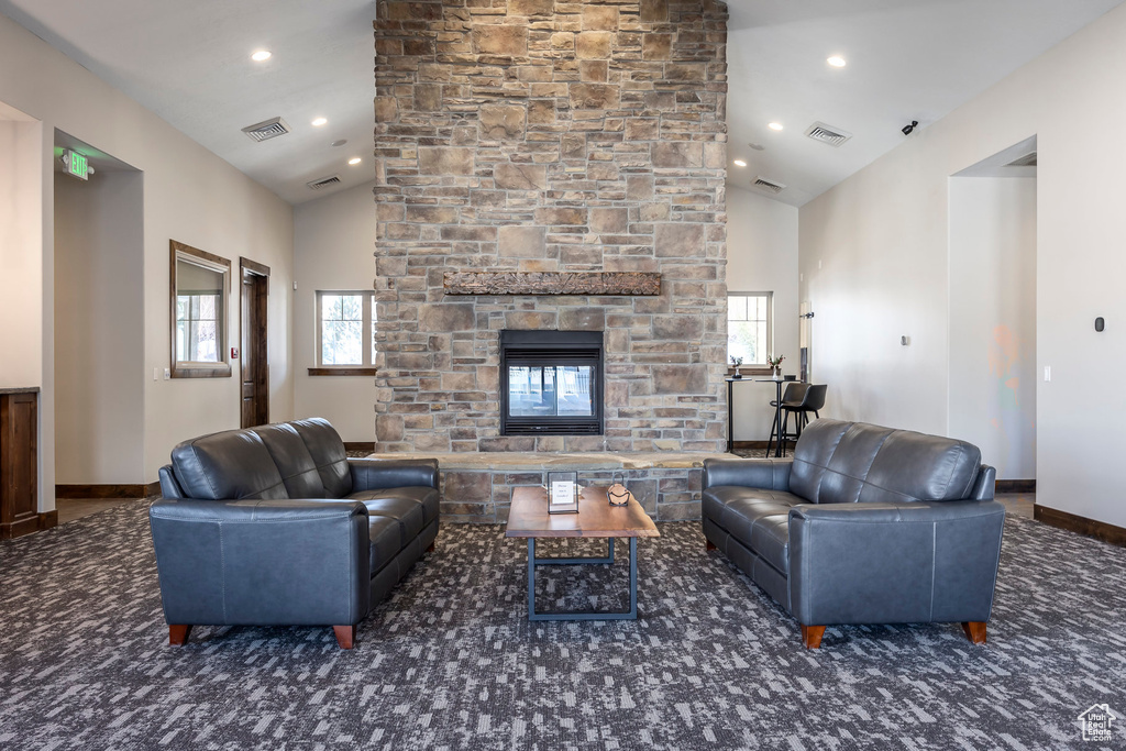 Living area featuring a fireplace, recessed lighting, and high vaulted ceiling